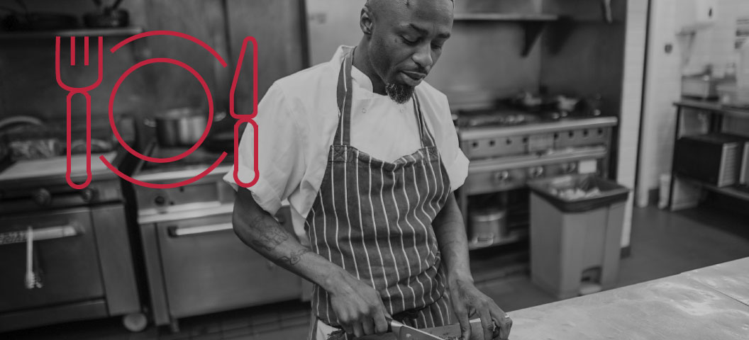 A man cutting food.